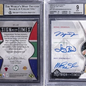 May include: A graded sports card with autographs of Michael Jordan, Larry Bird, and Magic Johnson. The card is encased in a protective holder with a Beckett Grading Services label. The card is labelled "Sign of the Times" and includes the text "Authentic".