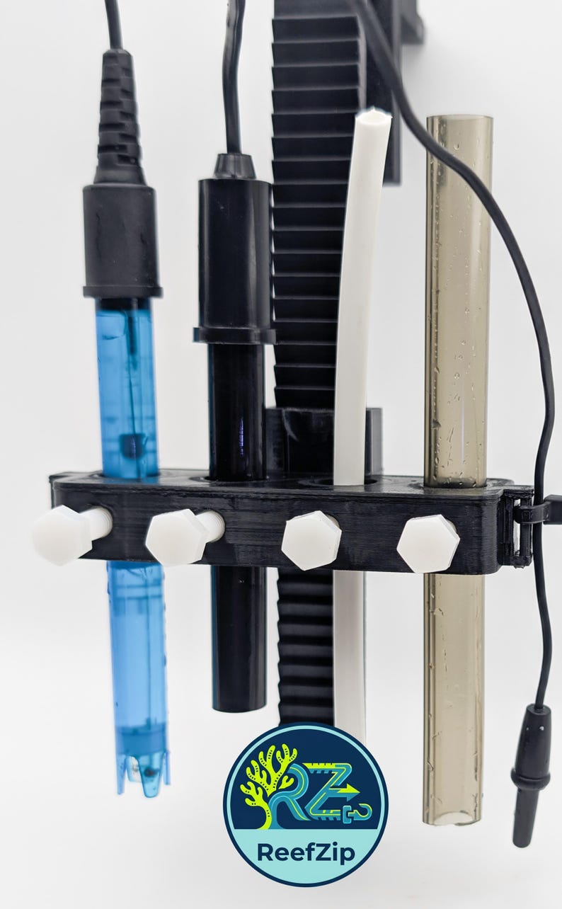 May include: A black plastic holder with various probes and tubes. The holder has white hexagonal knobs and supports a blue tube, a black tube, a white tube, and a clear tube. A logo with the text "ReefZip" is visible.