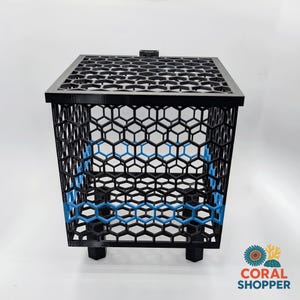 May include: A black, square, open-top container featuring a repeating hexagonal grid pattern on all sides and the base. A single horizontal band of bright blue hexagons is integrated into the black structure. The container stands on four small feet.