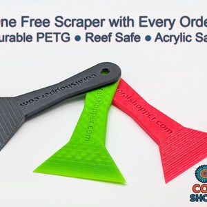 May include: Three plastic scrapers in black, green, and red, with a textured blade and a hole in the handle. The text "One Free Scraper with Every Order!" is at the top. The scrapers are durable, reef safe, and acrylic safe.