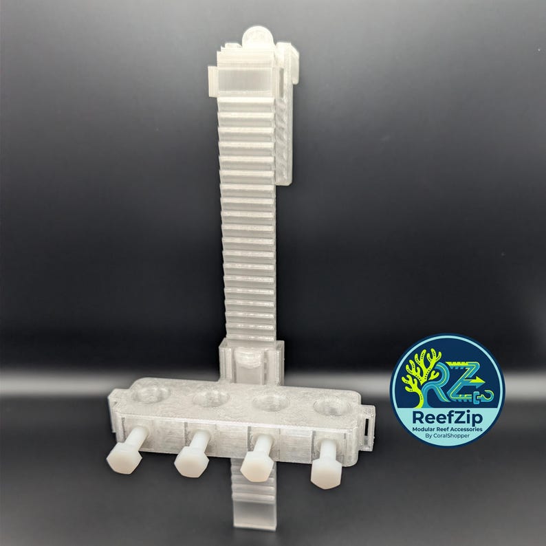 May include: A translucent, 3D-printed ReefZip modular reef accessory. The design features a vertical support with a series of horizontal slots and a base with four white, cylindrical pegs. A circular logo with text is visible.