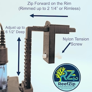 May include: Black modular reef accessory with the text "Zip Forward on the Rim" and "Adjust up to 16.5 cm Deep". The accessory includes a nylon tension screw and a logo that says "ReefZip".