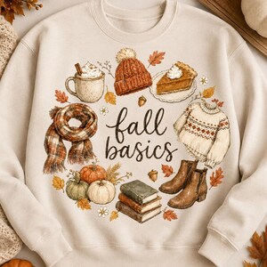 May include: A beige crewneck sweatshirt featuring a central graphic with the text fall basics surrounded by illustrations of a mug with whipped cream, a knit hat, a slice of pie, a plaid scarf, pumpkins, a sweater, books, and brown boots.