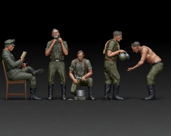 May include: A detailed miniature diorama featuring five figures in military-style uniforms. The figures are posed in various activities, including reading, adjusting clothing, and interacting with tools. The color palette is dominated by greens, browns, and blacks.