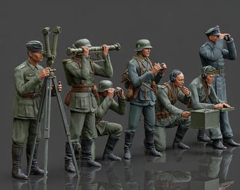 May include: A detailed miniature diorama featuring several figures in military uniforms. The figures are posed with binoculars, a tripod-mounted device, and other equipment. The color palette is primarily olive green and gray.