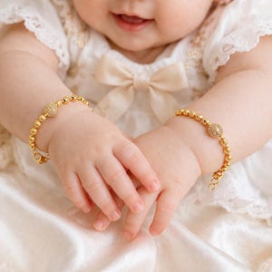 May include: A white ceramic mug with a black handle and the text "But First, Coffee" in a handwritten style. The mug is likely for hot beverages and has a glossy finish.