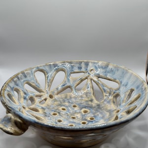 Hand made Fruit  Stainer pottery bowl.   It is food safe, dish washer safe, microwave safe, oven safe.  Great for washing berries.