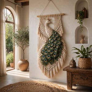 May include: A macrame peacock wall hanging with a natural, cream-colored body and a fan of green and blue peacock feathers. The wall art is suspended from a wooden dowel and adds a bohemian touch to the room.
