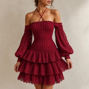 May include: A burgundy off-the-shoulder dress with long, open-weave sleeves and a tiered skirt. The dress features a halter neckline and a fitted bodice. The dress is made of a knitted material.