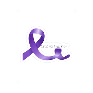May include: A sticker featuring a purple ribbon with the words "Crohn's Warrior" in a stylized font. The ribbon has a gradient effect, adding depth to the design. The sticker is on a white background.
