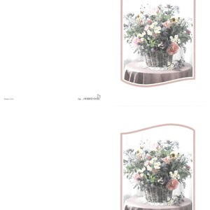 May include: A floral display in a wicker basket, with pink, white, and yellow blooms. The basket rests on a small, round table covered with a pink cloth. The image is framed with a soft pink border.