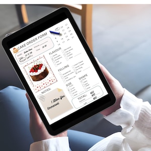May include: A tablet displaying a cake order form. The form includes sections for flavor, filling, size, and shape, along with a cake illustration. The form also has a section for notes that says "I Love You Emmanuel".