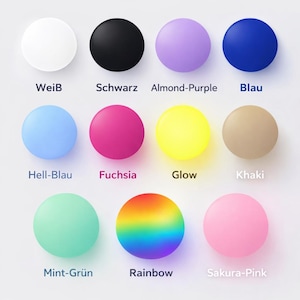 May include: A collection of twelve round objects in various colors, including white, black, purple, blue, light blue, fuchsia, yellow, beige, mint green, rainbow, and pink. Each object has a corresponding color name written below it.