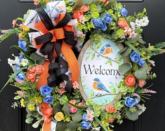 Corona de bienvenida para el jardín de pájaros azules