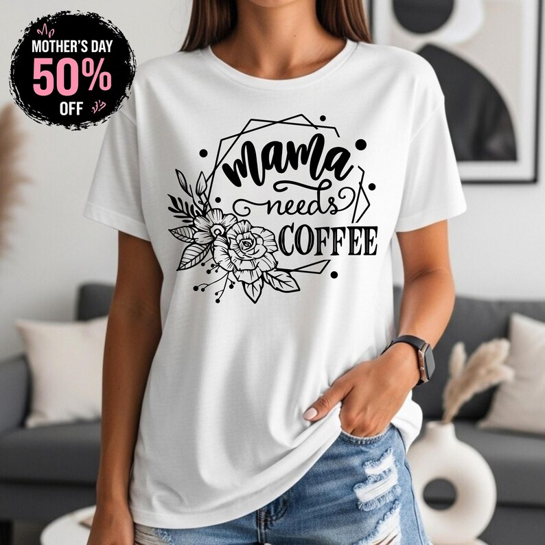 May include: White t-shirt with the text "Mama needs COFFEE" in a black floral design. A black circle with the text "Mother's Day 50% OFF" is in the upper left corner.