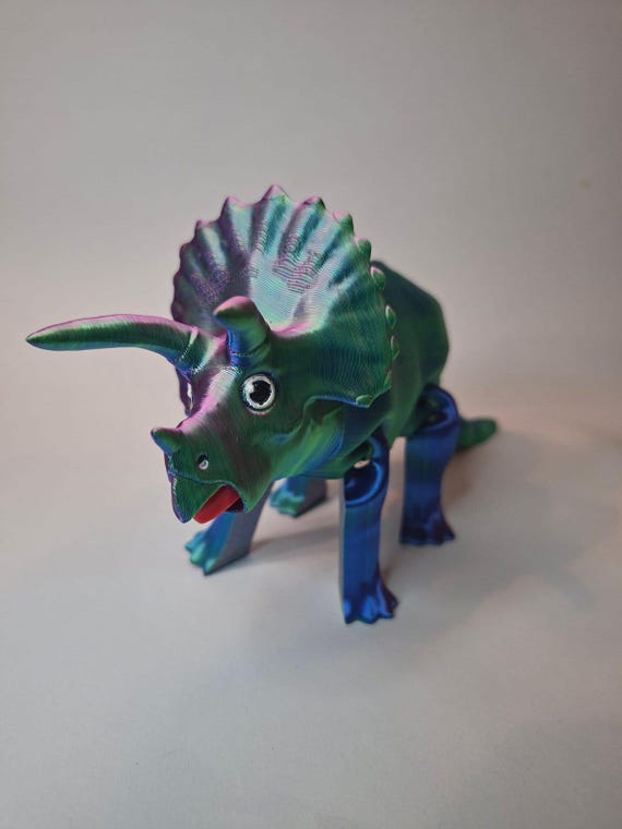 Iridescent 3D-printed articulated triceratops that shimmers and actually flexes — the iridescent filament and dino theme lift it above the standard flexi-print crowd.