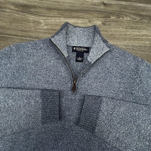 May include: A rustic wooden sign with the text "Welcome to our home" in white lettering. The sign features a distressed finish and a simple, inviting design, perfect for entryway decor.