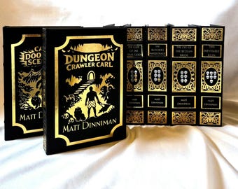 May include: A collection of five black hardcover books with gold foil detailing. The front cover of the primary book features the title Dungeon Crawler Carl by Matt Dinniman, with a graphic of a figure and a cat. The spines display various titles.