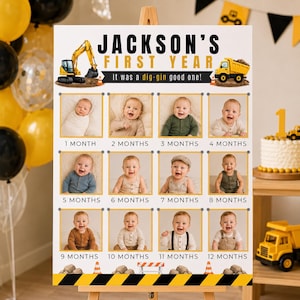 May include: A milestone poster for a baby's first year, featuring photos from 1 to 12 months. The poster has a construction theme with a yellow excavator and dump truck. Text reads "Jackson's First Year" and "It was a dig-gin good one!"