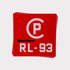 May include: A stack of red square stickers. Each sticker features a white "C" with a "P" inside, a black horizontal line, and the text "RL-93" in white, all against a red background. The stickers are stacked on a white surface.