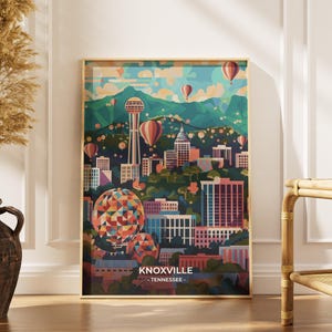 Puede incluir: Una impresión artística enmarcada con una colorida ilustración de Knoxville, Tennessee. La obra de arte representa el horizonte de la ciudad, montañas y globos aerostáticos en tonos azules, verdes, naranjas y rosas. El texto "KNOXVILLE - TENNESSEE" está en la parte inferior.