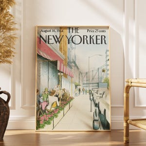 May include: A framed print of The New Yorker magazine cover dated August 16, 1964, featuring an illustration of a sidewalk cafe with pink awnings, people seated at tables, a city street with parked cars, and a bridge in the background.
