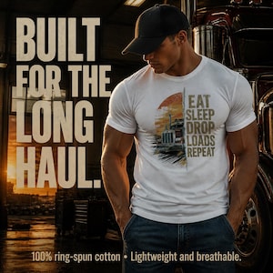 May include: A white short-sleeve t-shirt featuring a graphic of a semi-truck against a sunset background. The text reads "EAT SLEEP DROP LOADS REPEAT" next to the truck. The shirt is made of 100% ring-spun cotton and is lightweight and breathable.