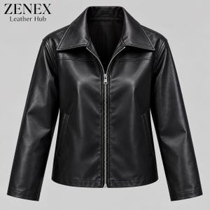 May include: A black jacket with a smooth finish, featuring a pointed collar, long sleeves, and a central silver-toned metal zipper closure. The garment includes two vertical side pockets and displays the text ZENEX Leather Hub in the corner.