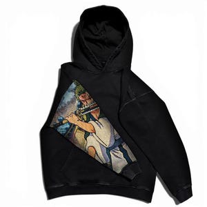 May include: Black hooded sweatshirt featuring a colorful graphic of a character playing a flute. The graphic is on the left side of the sweatshirt. The sweatshirt has a front pocket and a hood.