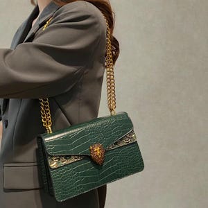 Retro green shoulder handbag with metallic chain strap and compact square silhouette for modern fashion styling