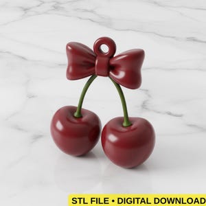 May include: A 3D-rendered image of a cherry pendant. The pendant features two cherries in a deep red color, connected by green stems to a red bow. The text "STL FILE • DIGITAL DOWNLOAD" is at the bottom.