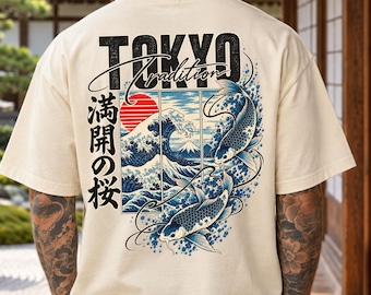 May include: A natural-colored t-shirt featuring a graphic on the back with the text TOKYO, Tradition, and Japanese characters. The design includes two koi fish, a red sun, and a stylized wave pattern resembling Mount Fuji.