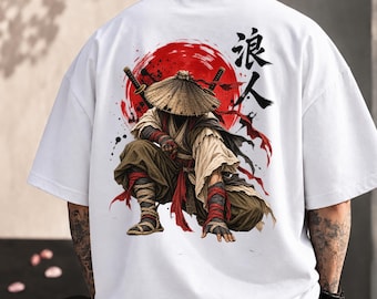 May include: A white short-sleeved t-shirt featuring a graphic on the back of a crouching figure wearing a conical hat and traditional clothing, positioned in front of a large red circle with black Japanese kanji characters above it.