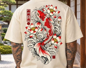 May include: A beige t-shirt featuring a large graphic on the back of a red and white koi fish swimming among white and red lotus flowers and stylized water waves. The design includes Japanese text in a vertical red rectangular border.