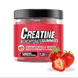 May include: A clear plastic jar with a black lid, filled with red gummies. The label reads "Creatine Monohydrate Gummies" and includes text about muscle growth and strength. Fresh strawberries are next to the jar.