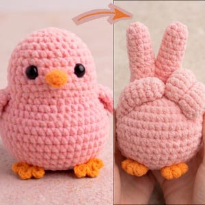 May include: A handmade, pink crochet chick with black eyes and an orange beak and feet. The chick is shown in two views: one facing forward and the other with a peace sign hand gesture.