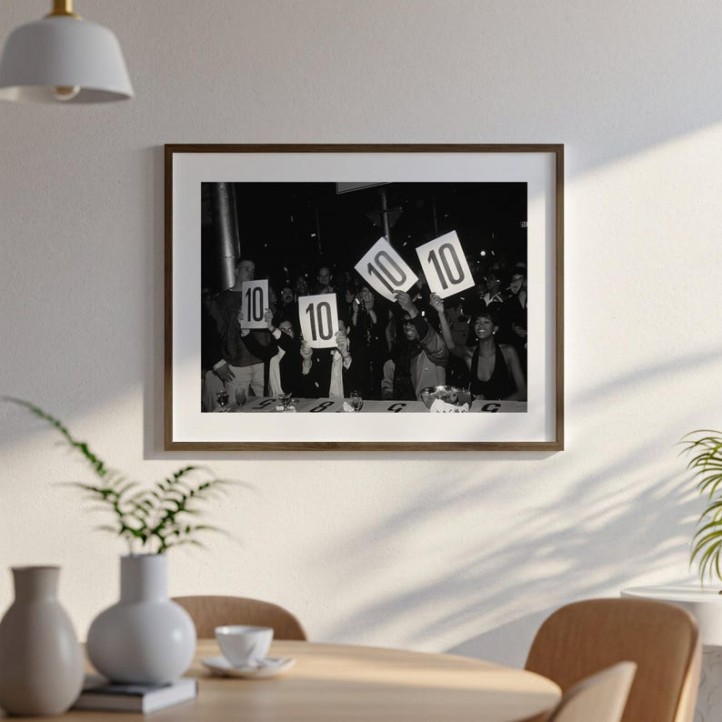 A black and white photograph of a group of people holding up signs with the numbers "10" on them, suggesting they are participating in a contest or event.
