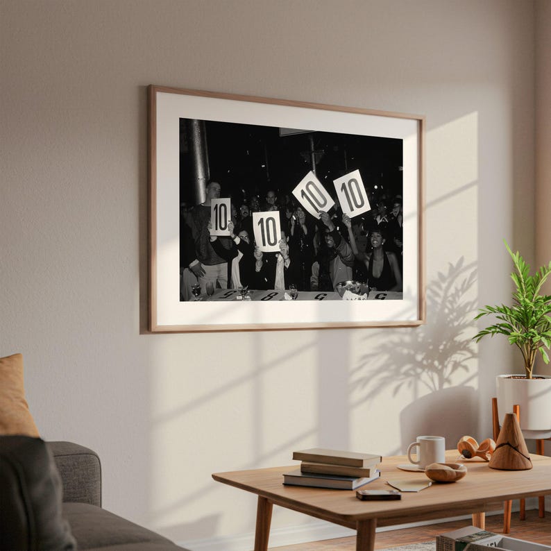 a black and white photograph of a group of people holding up signs with the number "10" on them, suggesting a celebration or event.