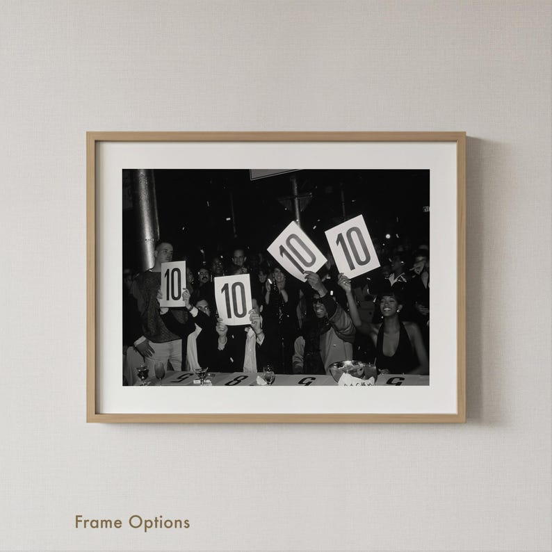 A black and white photograph of a group of people holding up signs with the numbers "10" and "10" on them.