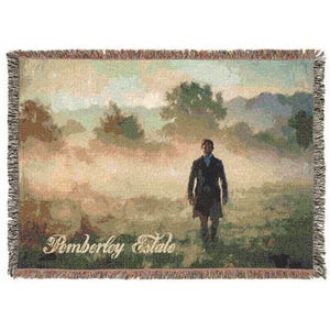 May include: A rectangular woven throw blanket featuring a landscape scene with a person in a dark coat walking through a misty field. The text Pemberley Estate is printed in a light script font at the bottom. The blanket has a fringed edge.