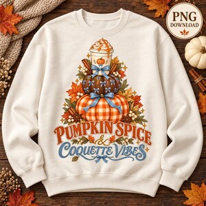 May include: A cream-coloured crewneck sweatshirt featuring a graphic of stacked pumpkins and a coffee cup topped with whipped cream. The design includes blue bows, autumn leaves, cinnamon sticks, and the text PUMPKIN SPICE & COQUETTE VIBES.