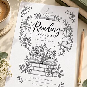 May include: A white paper reading journal cover featuring black line art illustrations of stacked books, flowers, a teacup, and a crescent moon. The text reads Reading JOURNAL A little space for every story, THIS JOURNAL BELONGS TO, and YEAR.