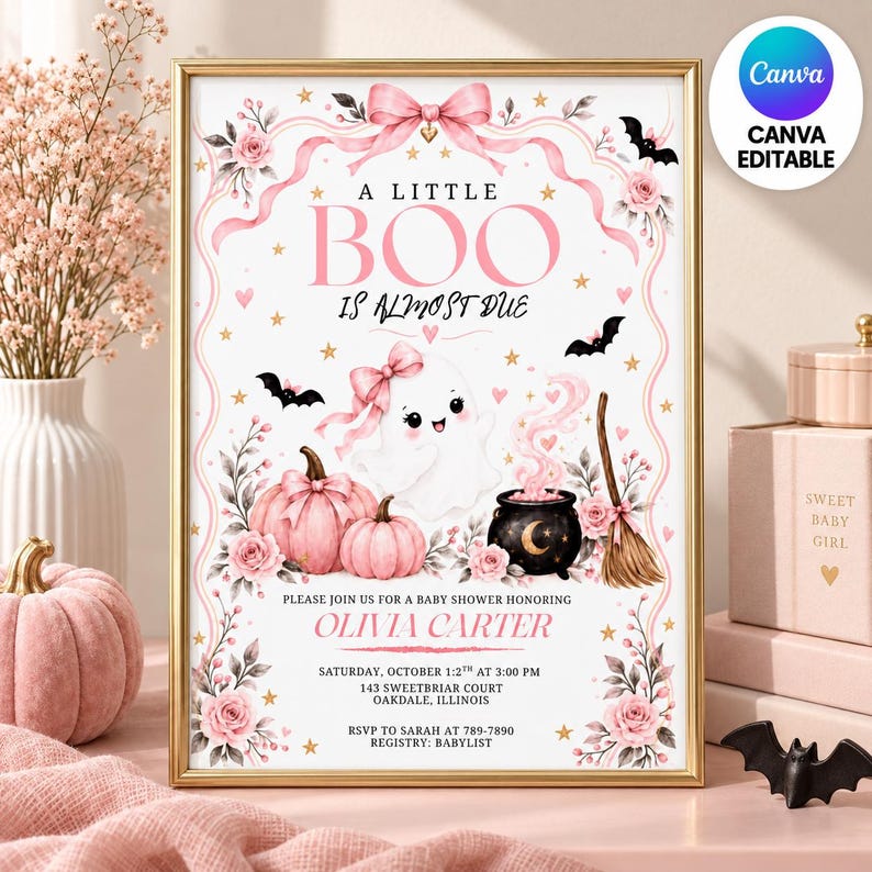 May include: A rectangular baby shower invitation sign featuring a white background with pink floral accents, a ghost with a pink bow, two pink pumpkins, a black cauldron, and a broom. Text reads: A LITTLE BOO IS ALMOST DUE, OLIVIA CARTER.