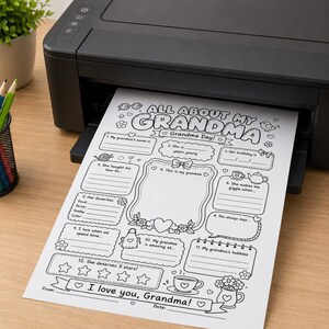 May include: A black printer outputting a white sheet of paper featuring a black and white printable activity page titled All About My Grandma. The page includes twelve fill-in-the-blank sections, decorative illustrations of flowers, hearts, and a teapot, and a five-star rating area.