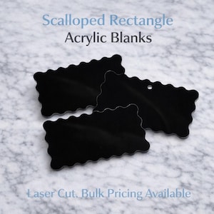 May include: Black scalloped rectangle acrylic blanks. The image shows three laser-cut acrylic shapes with a glossy finish. Text at the top reads "Scalloped Rectangle Acrylic Blanks". The background is a marble pattern.
