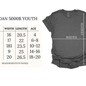 May include: A dark grey t-shirt displayed next to a size chart labelled GILDAN 5000B YOUTH. The chart lists sizes XS through XL with width and length measurements in inches, alongside corresponding age ranges for each size category.