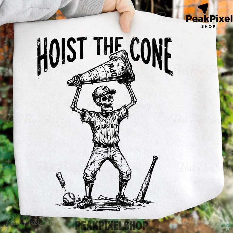 May include: Black and white graphic tee featuring a skeleton in a baseball uniform holding a traffic cone above its head. The text "HOIST THE CONE" is above the skeleton. A baseball bat, ball, and bones are at the skeleton's feet.