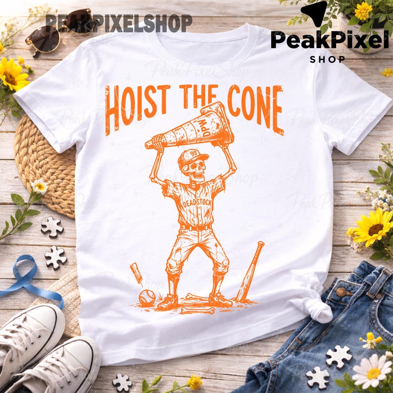 May include: White t-shirt with an orange graphic of a skeleton in a baseball uniform holding a traffic cone above its head. The text "HOIST THE CONE" is above the skeleton. Baseball bat, ball, and other baseball equipment are also in the graphic.