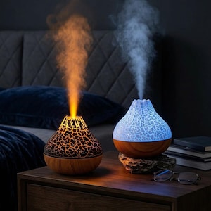 May include: A white ceramic mug with a black handle and the text "But First, Coffee" in a bold, black font. The mug is set against a blurred background, highlighting its clean design.