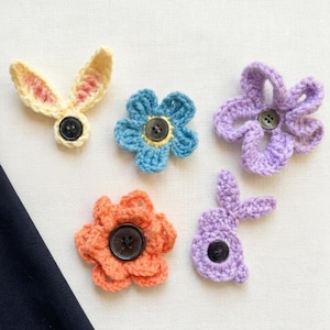 May include: A set of three ceramic mugs with a speckled, matte finish. The mugs are in cream, light grey, and dark grey. Each mug has a simple, minimalist design, ideal for coffee or tea.